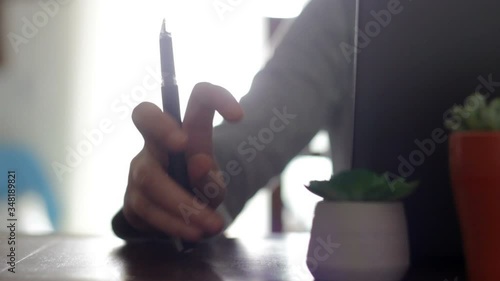 Nervous woman tapping with pen on table