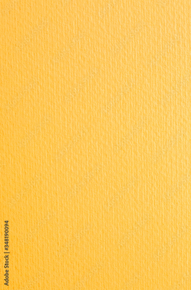 Naklejka premium Intence yellow paper background. Orange textured cardboard with no objects.