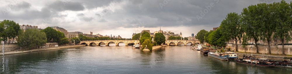 Paris, France - May 10, 2020: 'Pont Neuf', the oldest bridge in Paris with the 'ile de la cité' in the middle of the photo on a stormy day