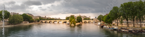 Paris, France - May 10, 2020: 'Pont Neuf', the oldest bridge in Paris with the 'ile de la cité' in the middle of the photo on a stormy day