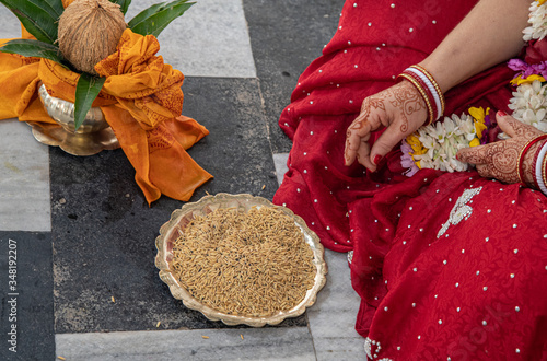 Hindu bride and groom held grain in their hands, participating in the wedding ritual. Beautiful traditional Indian wedding ceremony. Hindu wedding. indian engagement. Hindu the Vedic Yagya ceremony photo