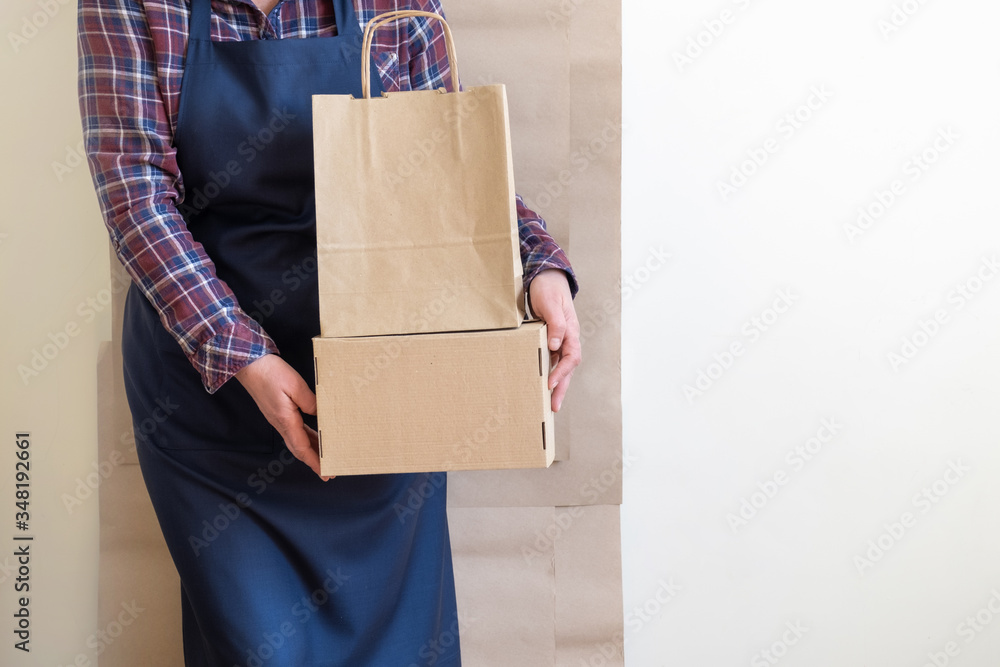 Worker delivery service packing bag box apron packer shipping open coffee to go Worker delivery service packing bag box apron packer shipping open coffee to go