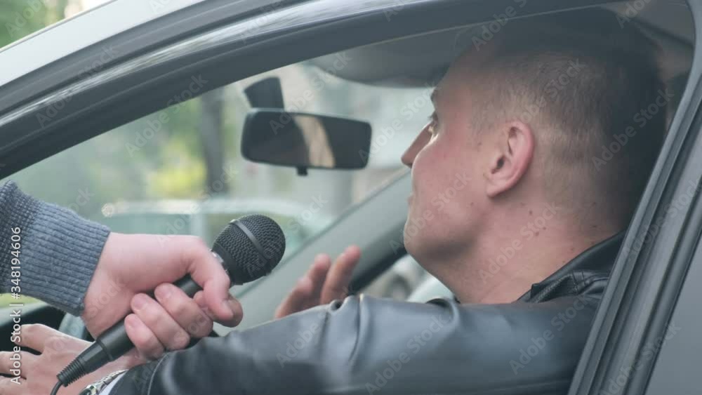 Unhappy and aggressive driver gives interview to journalist, closeup Unhappy and aggressive driver gives interview to journalist, closeup