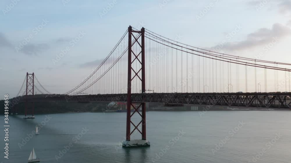 Aerial Reveal Drone Shot of the 25th April Bridge and Yachts over the Tagus River, Lisbon, Portugal Aerial Reveal Drone Shot of the 25th April Bridge and Yachts over the Tagus River, Lisbon, Portugal