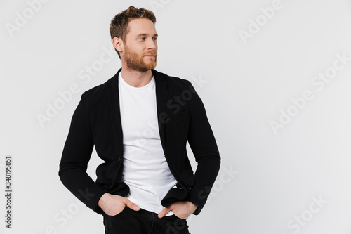 Image of unshaven pleased man in jacket posing and looking aside © Drobot Dean