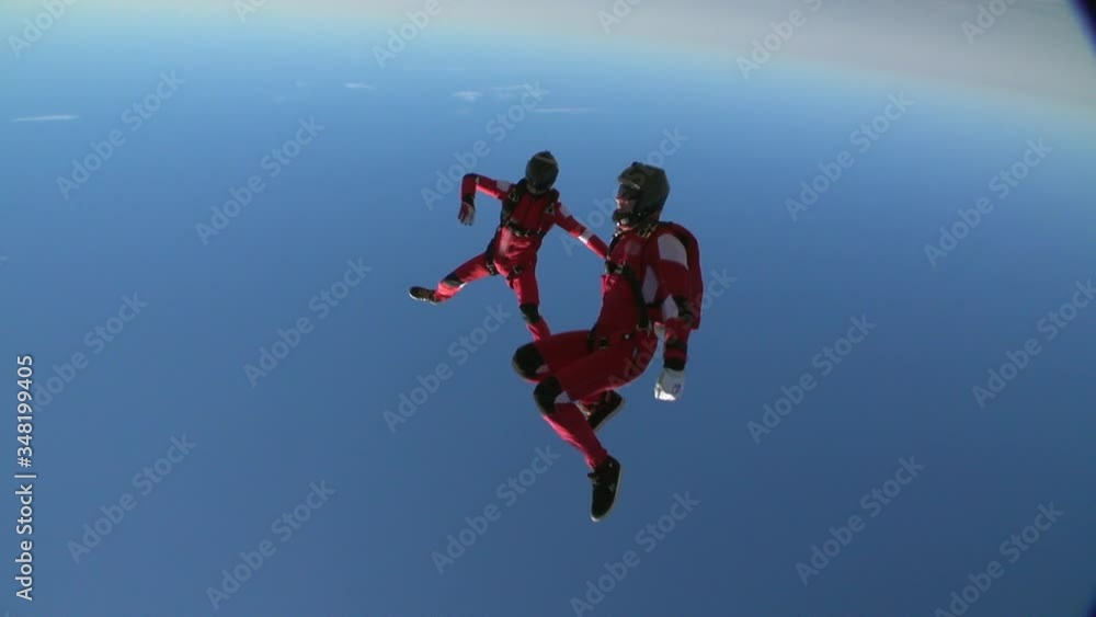 Two sports parachutist build a figure in free fall. Extreme sport concept. Two sports parachutist build a figure in free fall. Extreme sport concept.