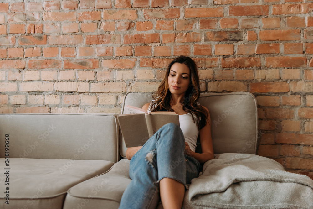 beautiful girl reading book at home during self isolation beautiful girl reading book at home during self isolation