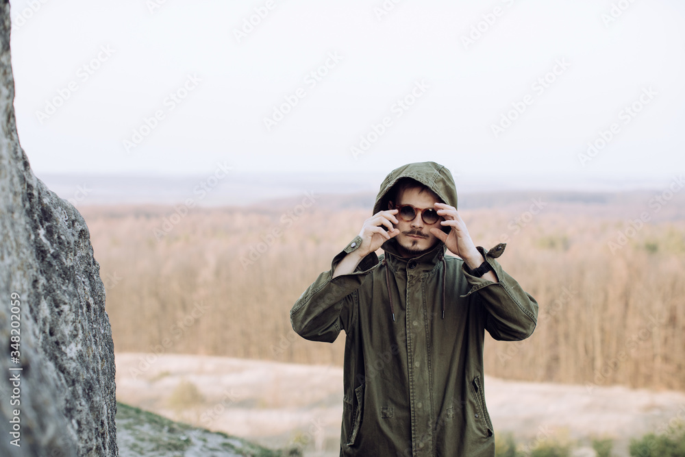 Portrait of a young stylish hipster man with glasses outdoors Portrait of a young stylish hipster man with glasses outdoors