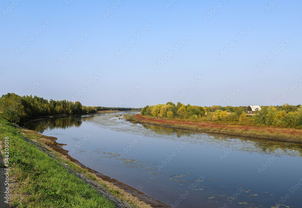 Autumn in the Russian North. Suspension bridge in the village Sikirica Arkhangelsk region. Spectacular perspective and symmetry.