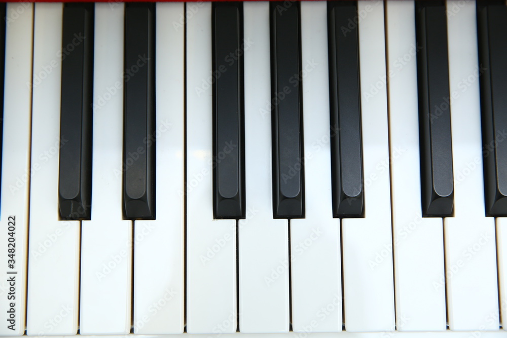 close frontal . The piano was set up in the music room to allow the pianist to rehearse before the classical piano performance in celebration of the great businessman's success .close-up of piano keys close frontal . The piano was set up in the music room to allow the pianist to rehearse before the classical piano performance in celebration of the great businessman's success .close-up of piano keys
