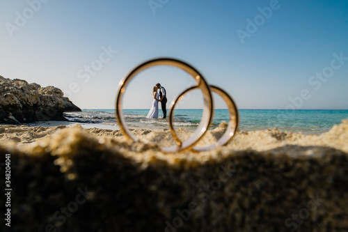 large rings on the sand and a small lovers on the horizon 