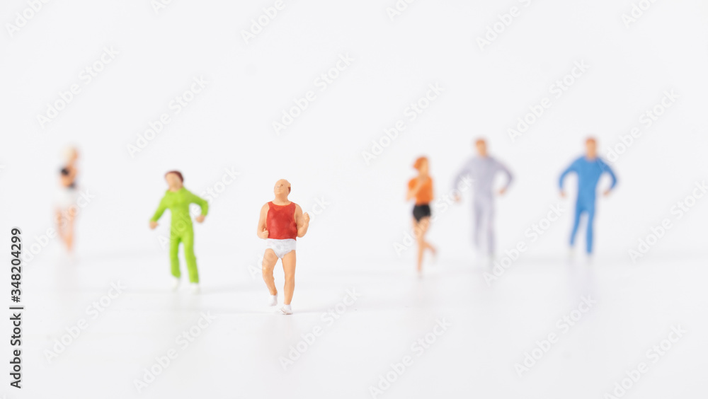 miniature people running on white background miniature people running on white background