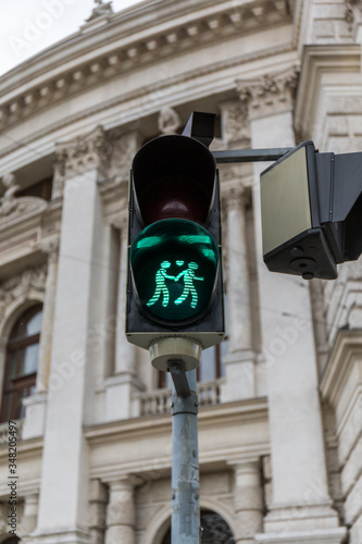Photography green traffic light with a loving couple crossing in Vienna