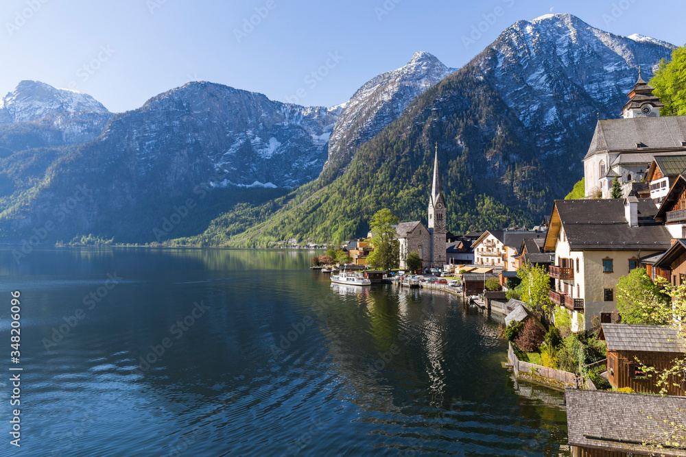 Classic view of famous old town Hallstatt and alpine deep blue lake on a beautiful sunny day, Salzkammergut, Austria