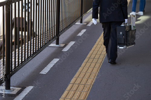 Japanese train conductor at station
