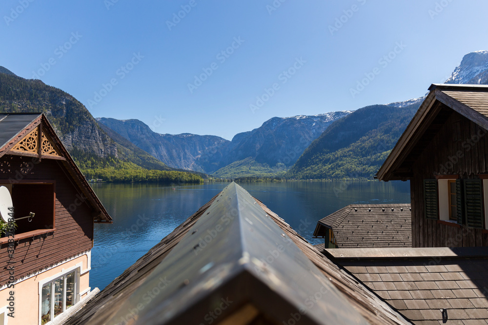 closeup of a roof of a Hallstatt house from which you can see the mountains and the lake