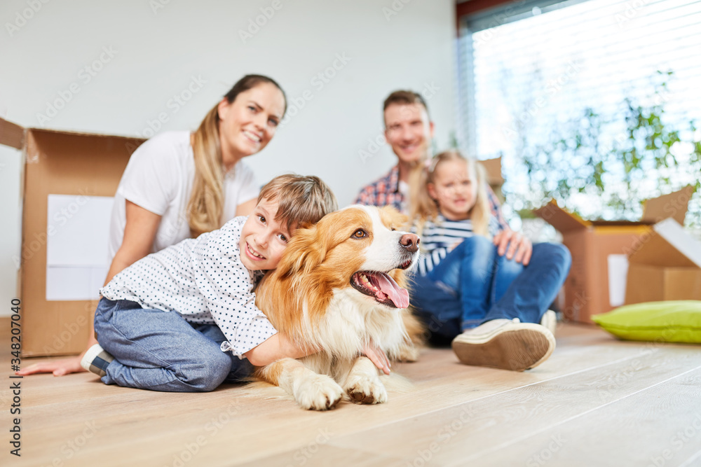 Family with children and dog in the new house