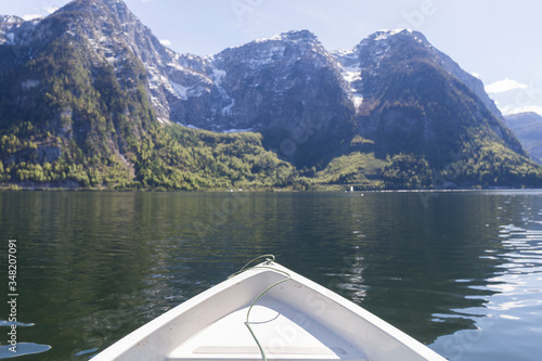 part of the bow of a white boat in the middle of a lake between mountains in austrian tyrol