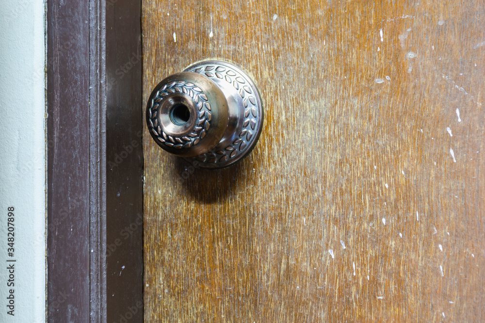 old wooden door knob closed reflect with lighting in room old wooden door knob closed reflect with lighting in room