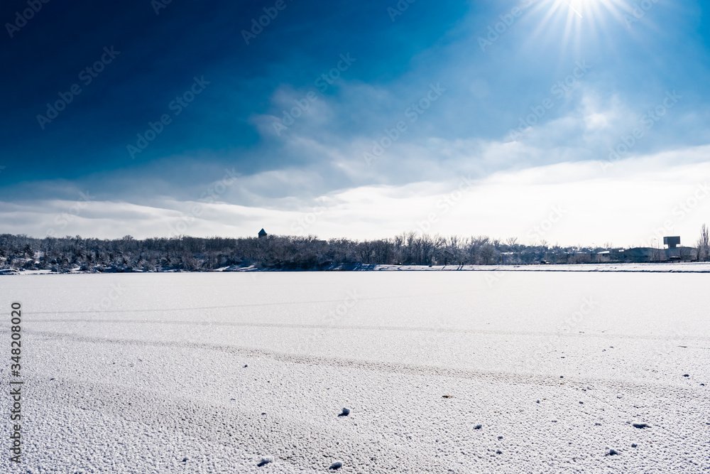 Spacious snow landscape. River and hills in Russia, white winter on the terrain, a lot of fluffy snow and ice under a beautiful blue sky. Rostov region, town of Shakhty, the river Grushevka Spacious snow landscape. River and hills in Russia, white winter on the terrain, a lot of fluffy snow and ice under a beautiful blue sky. Rostov region, town of Shakhty, the river Grushevka
