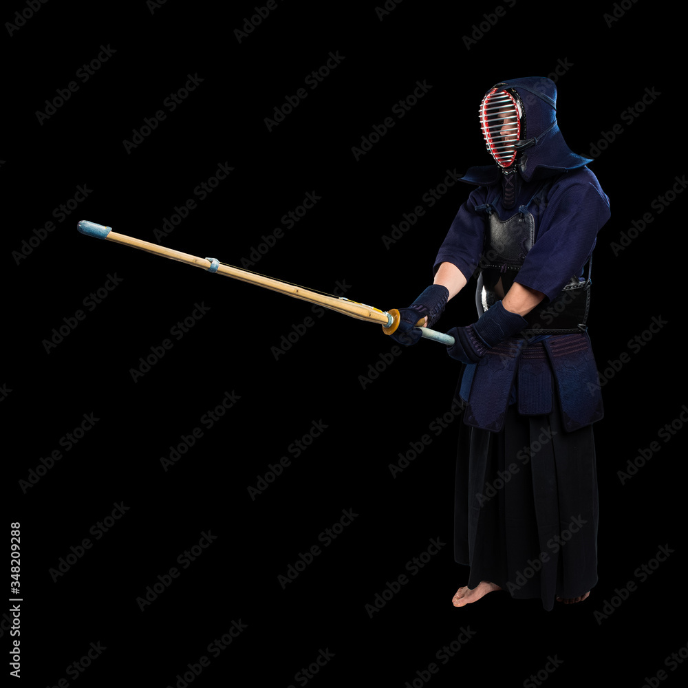 male in tradition kendo armor with shinai (bamboo sword). shot in studio. Isolated with clipping path on black background male in tradition kendo armor with shinai (bamboo sword). shot in studio. Isolated with clipping path on black background