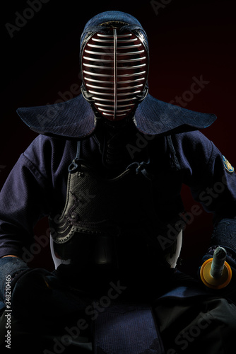 Fototapeta Naklejka Na Ścianę i Meble -  Male in tradition kendo armor with Samurai sword katana. shot in studio. Isolated on black background