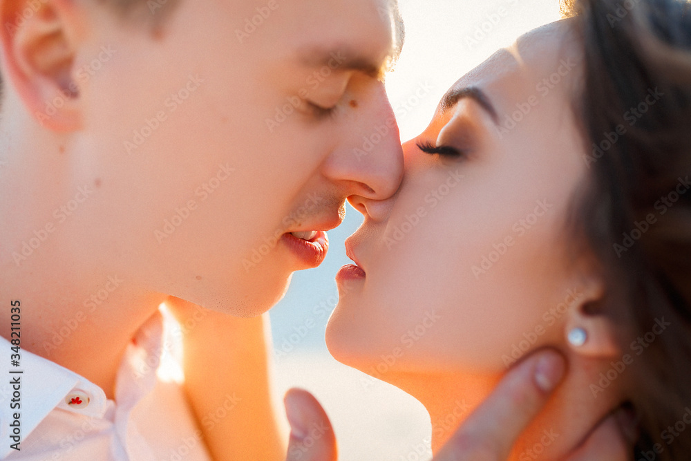 Newlyweds kisses in the desert at sunset Newlyweds kisses in the desert at sunset