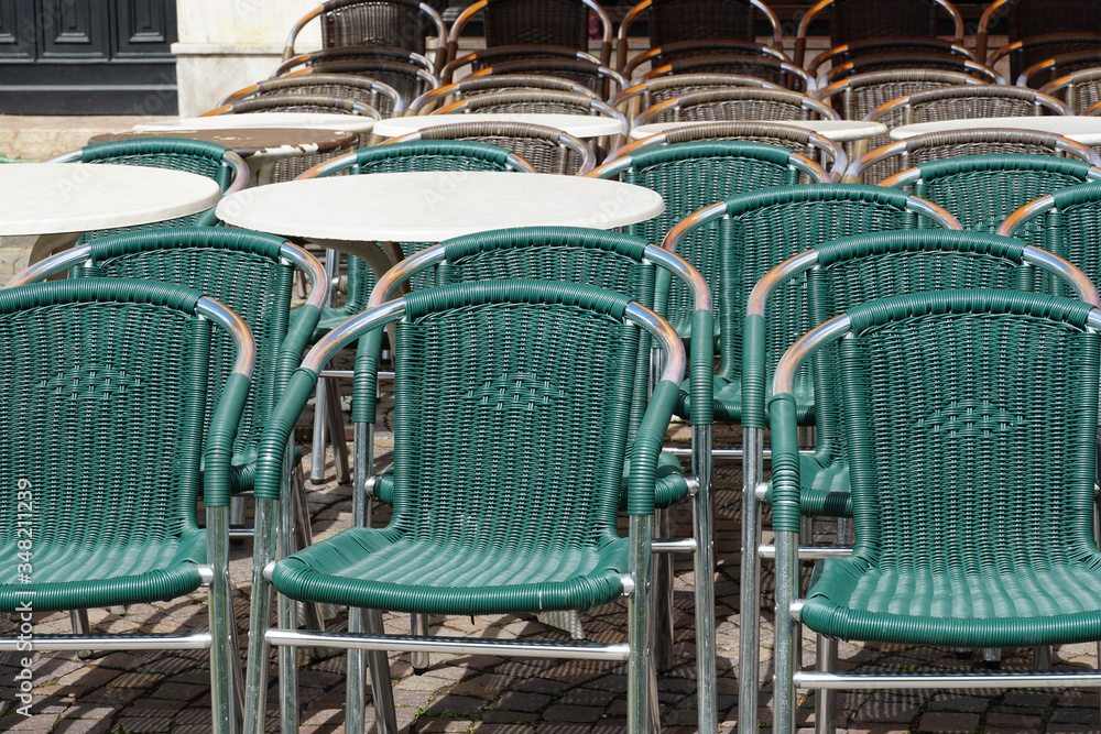 Italian restaurants and bars in Merano, South Tyrol, are still closed because of COVID-19. Chairs and tables stacked up and chained together. No operation. Italian restaurants and bars in Merano, South Tyrol, are still closed because of COVID-19. Chairs and tables stacked up and chained together. No operation.