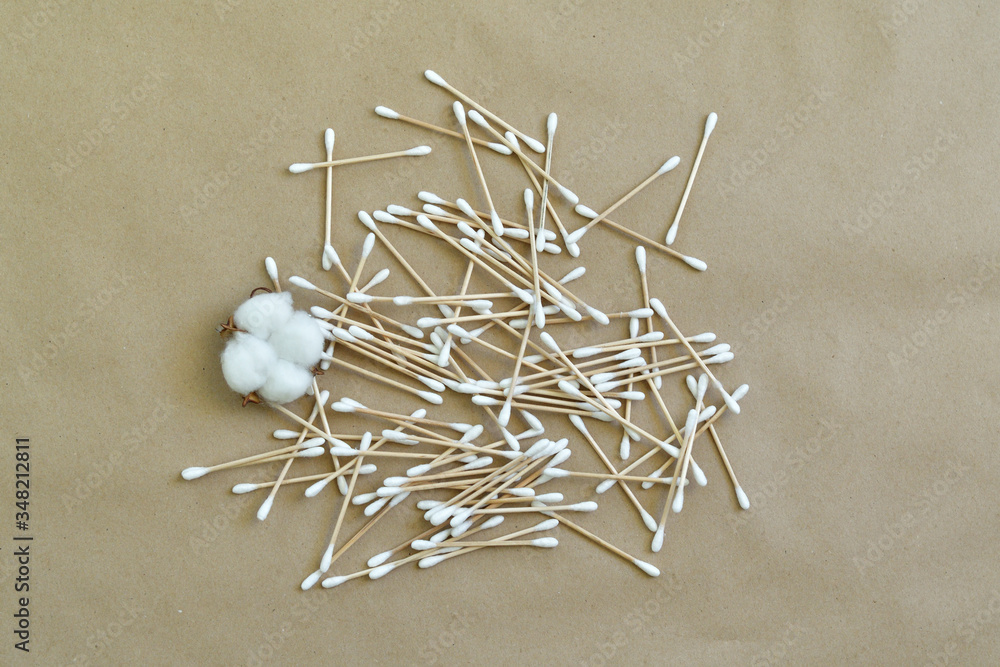 Set of bamboo cotton buds and cotton flower on Paper background. Wooden cotton buds for ear.Zero waste, life without plastic. Ecology concept. Save the world.