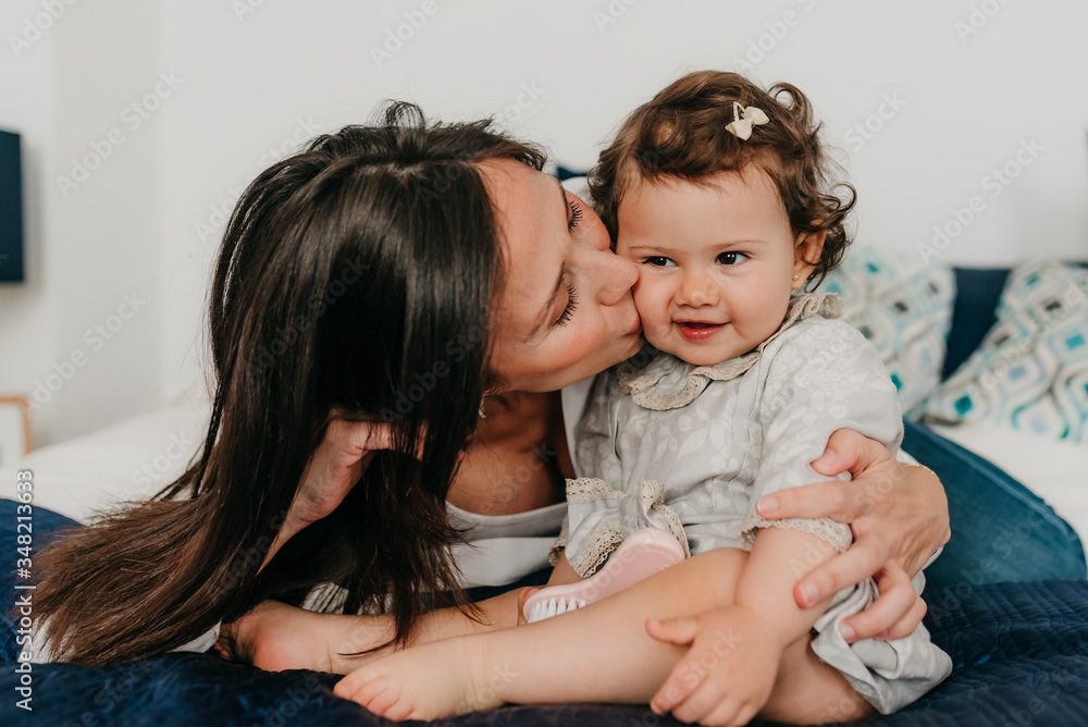 young pretty mother plays with her daughter young pretty mother plays with her daughter