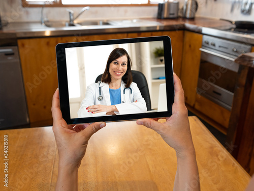 COVID-19 Online medical care. Patient video calling online doctor in virtual medical consultation photo