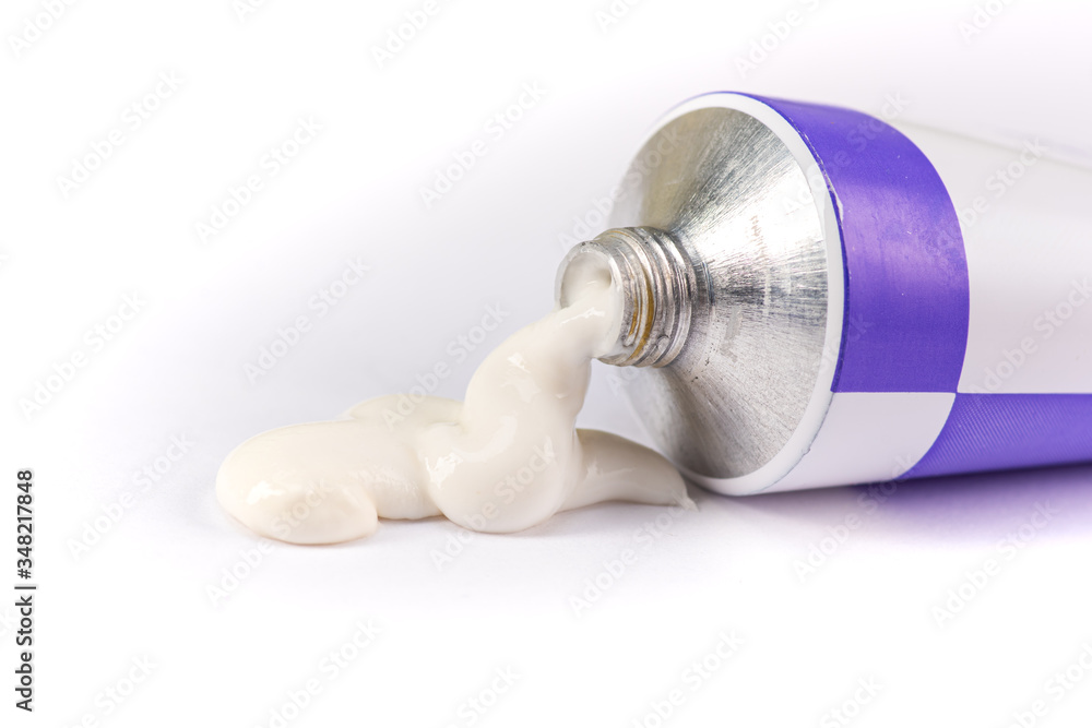 ointment or cream for external use is slightly squeezed out of a tube on a white background on a white background - obrazy, fototapety, plakaty 