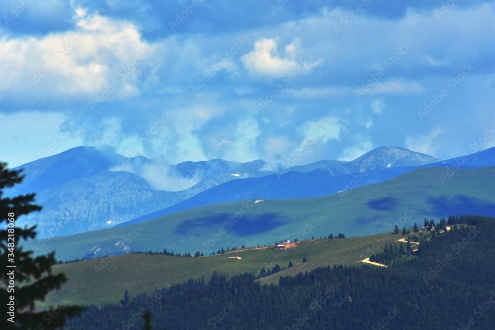 spring mountain landscape with green grass at high altitude