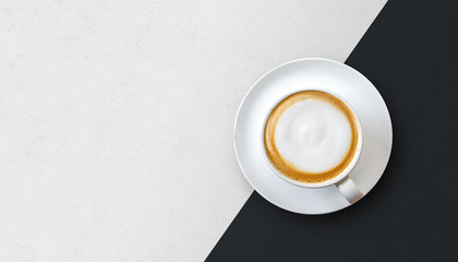 cup of coffee hot latte on white and black table background. top view