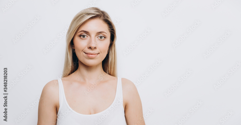 Young pretty woman with professional make-up applied, against a light background Young pretty woman with professional make-up applied, against a light background