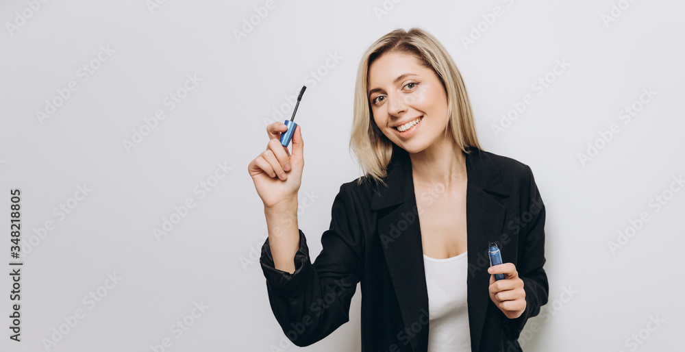 A pretty young woman is using different make-up accessories for application of make-up A pretty young woman is using different make-up accessories for application of make-up