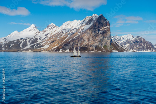 Arctic landscape in Svalbard with small sailing ship