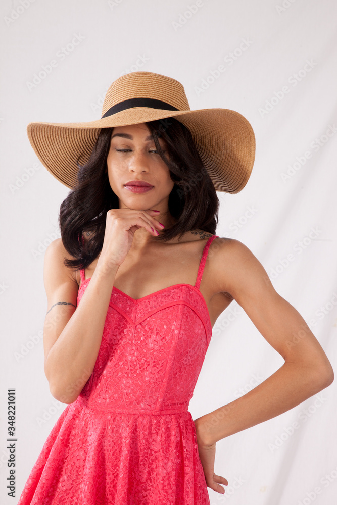Pretty woman in pink sun dress and straw hat