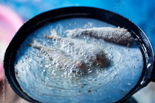 Frying small sardines fish, Chefchouen, Morocco photo