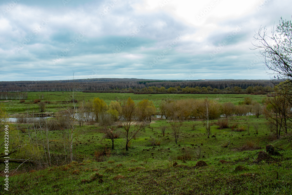 A beautiful landscape of central Russia in early spring - green hills and a river in the valley. A beautiful landscape of central Russia in early spring - green hills and a river in the valley.
