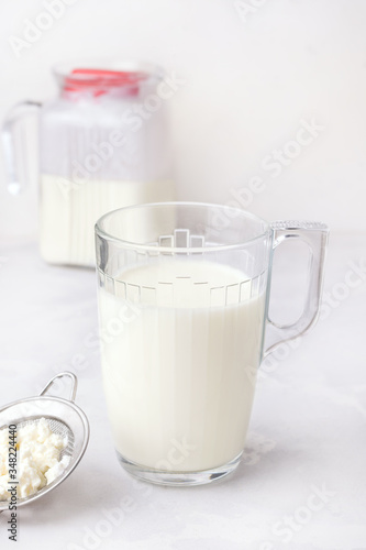 Fermented milk drink kefir on a white background. Vertical photo. Healthy drinks for digestion