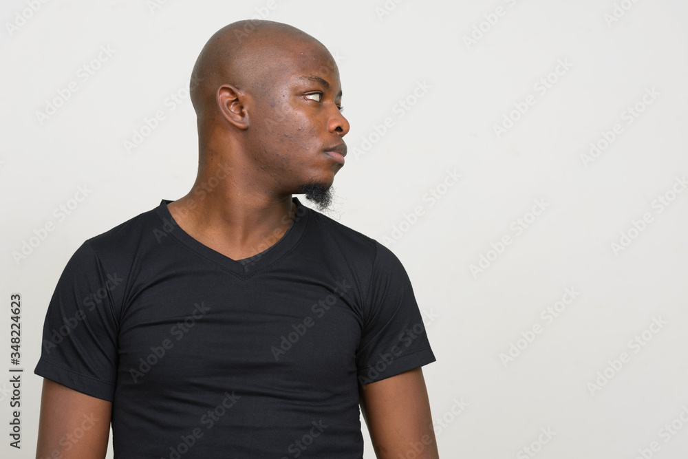 Profile view of young handsome bald African man Profile view of young handsome bald African man