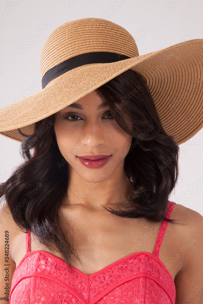 Happy Caucasian woman in a pink sun dress and a straw hat. Happy Caucasian woman in a pink sun dress and a straw hat.
