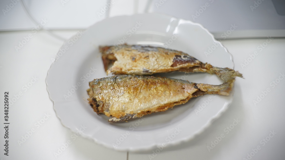 fried fish on white dish on table fried fish on white dish on table