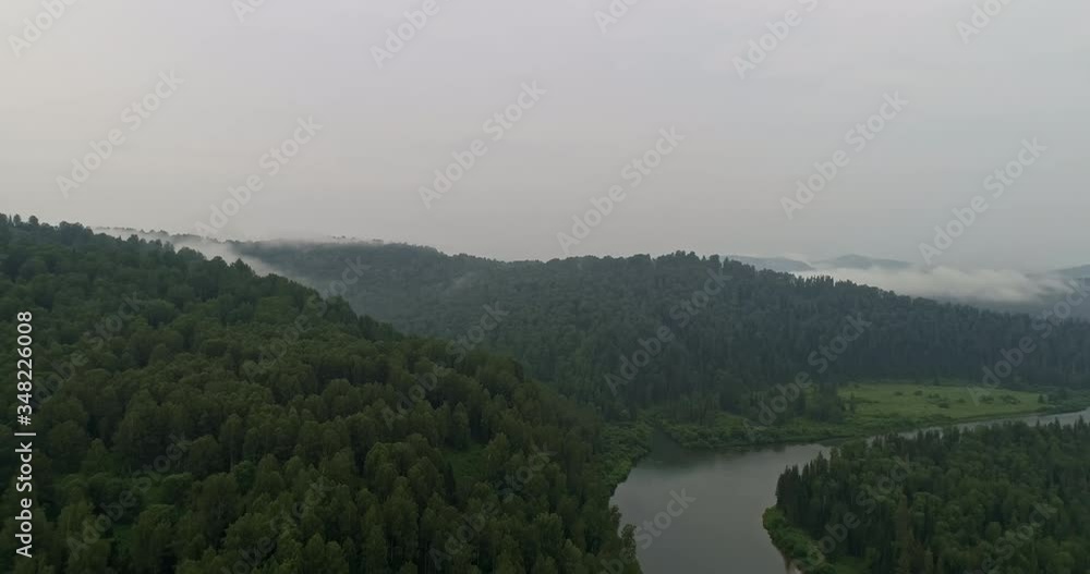 AERIAL Panoramic view: unique view of the Siberian taiga with a river. morning mist in the green mountains with a beautiful river. aerial view of mountain river. 4k video footage AERIAL Panoramic view: unique view of the Siberian taiga with a river. morning mist in the green mountains with a beautiful river. aerial view of mountain river. 4k video footage