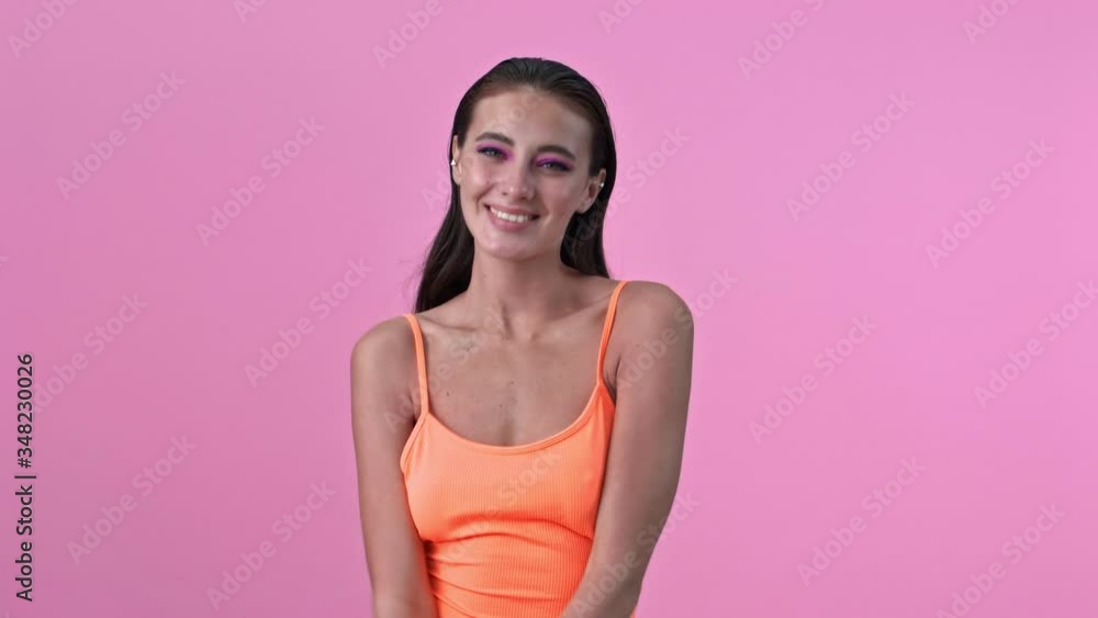 Young cute confused unsured woman isolated over pink wall posing background Young cute confused unsured woman isolated over pink wall posing background