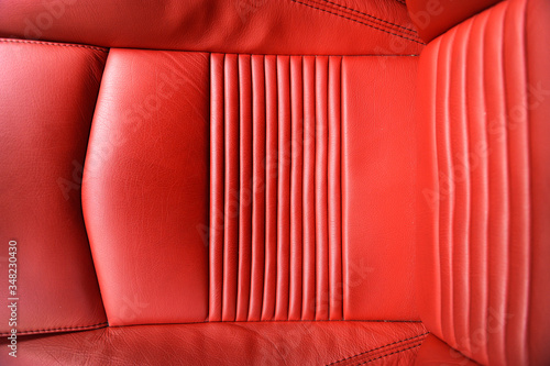  red leather seat of a car maserati with various folds and details in order to look like a graphic background photo