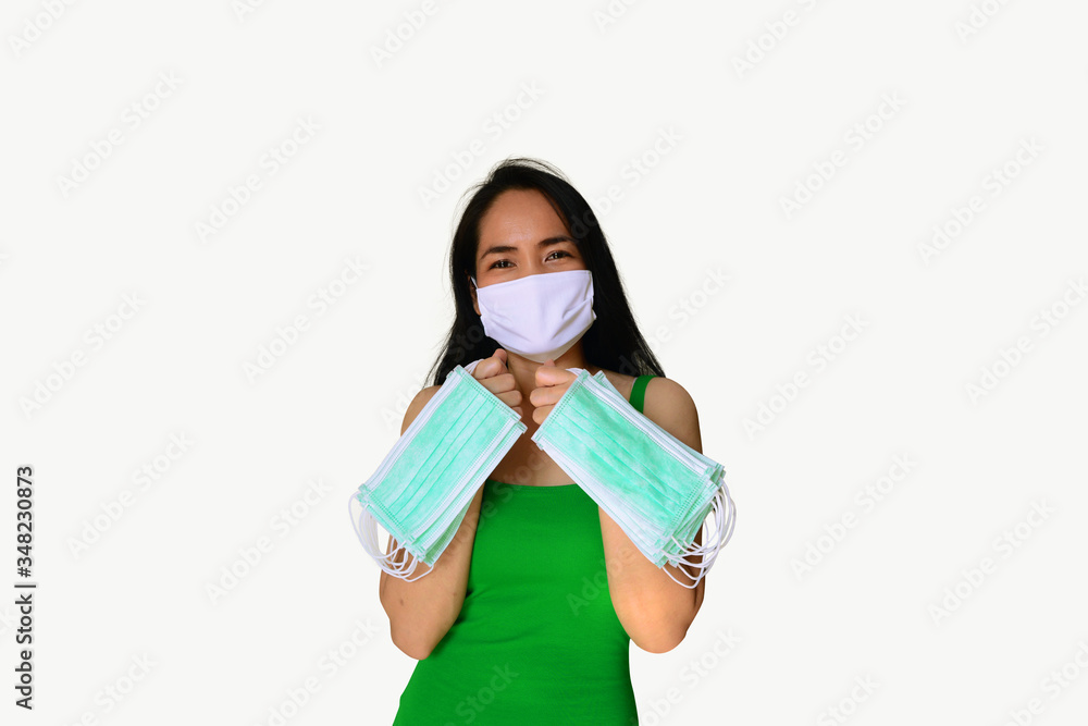 asian woman with smiling in eyes wear a white mask and green dress holding many face mask in her 2 hands on white background isolated with clipping path asian woman with smiling in eyes wear a white mask and green dress holding many face mask in her 2 hands on white background isolated with clipping path