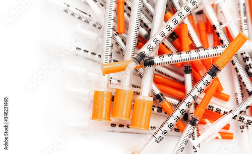pile of syringes for diabetes on white background, healthcare concept.