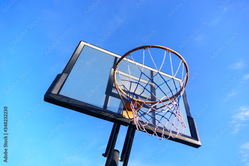 Basketball shield with a basket on the sky background Basketball shield with a basket on the sky background